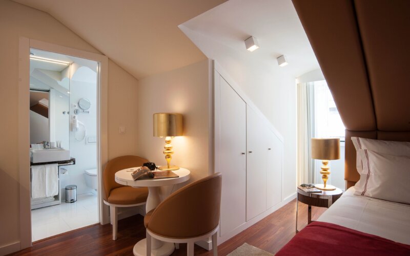 Stylish hotel room interior in Lisbon with modern furniture and warm lighting, gay hotels Lisbon