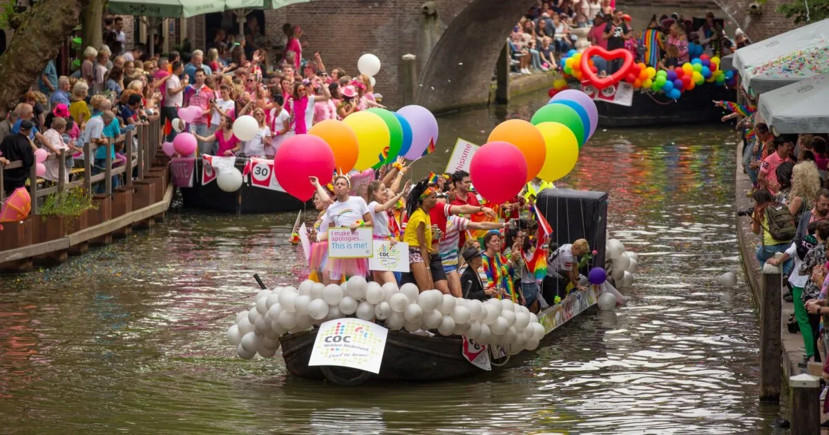 Pride parade boats on a canal in the Netherlands during WorldPride Amsterdam 2026