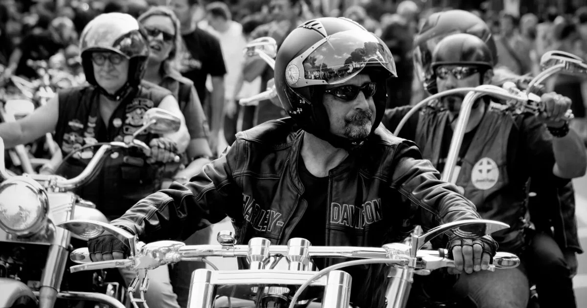 Black-and-white photo of bikers at an outdoor event, Lisbon Meets Fetish leather crowd