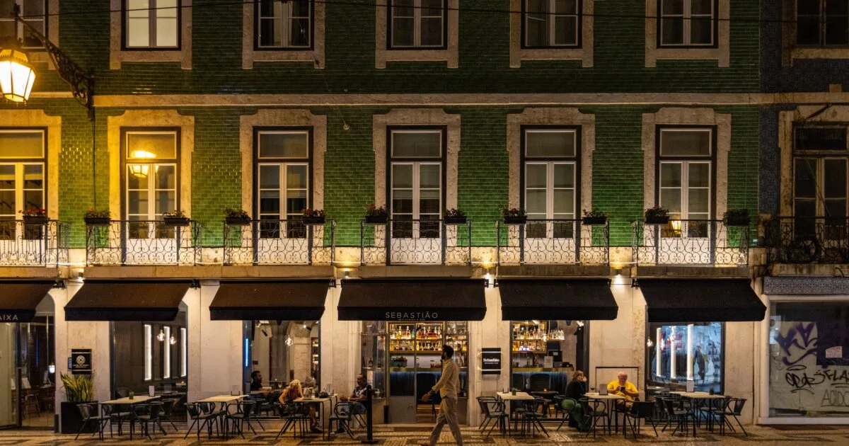 Lisbon café and bar at night with outdoor seating on a lively street in Bairro Alto