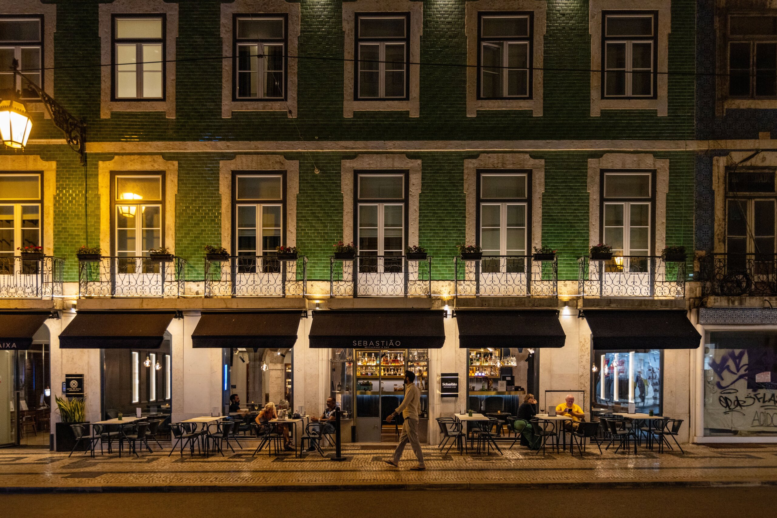 Lisbon café and bar at night with outdoor seating on a lively street in Bairro Alto