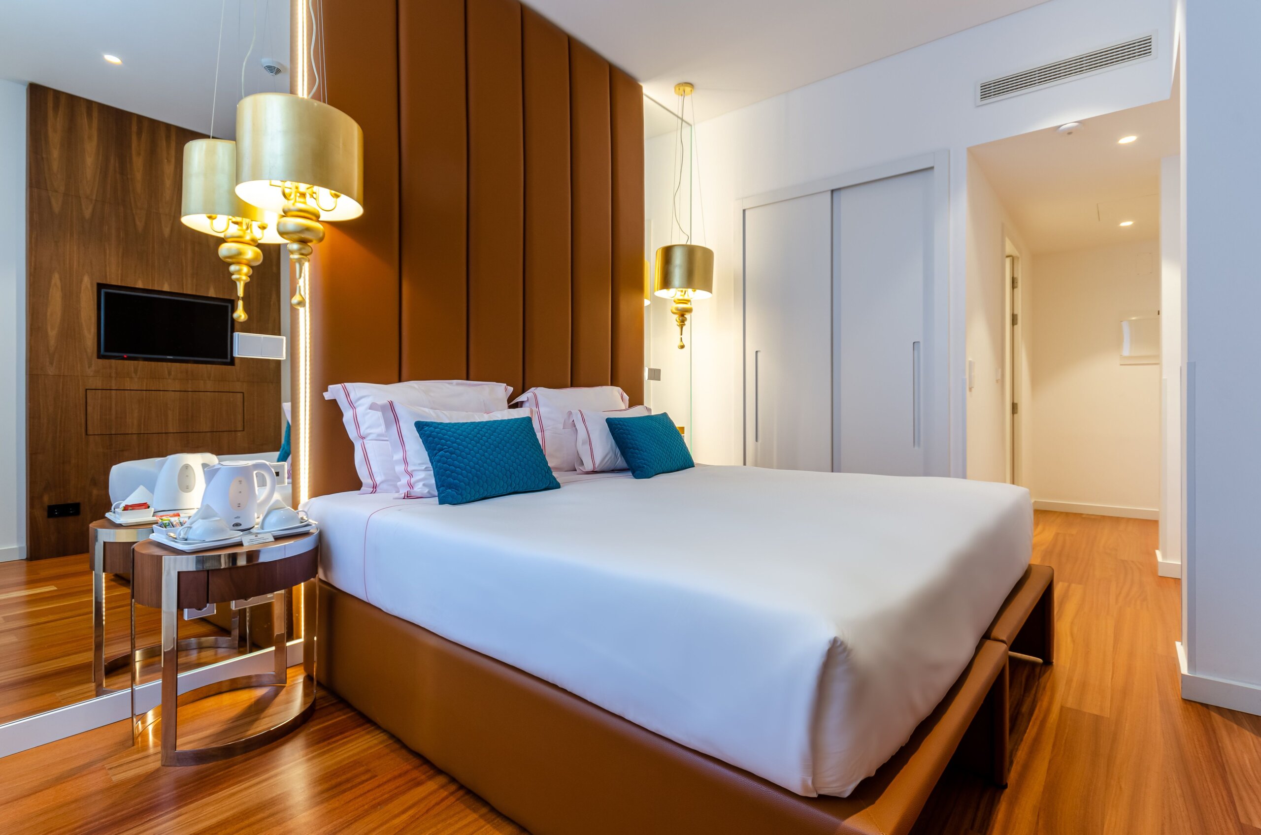 Elegant boutique hotel room in Lisbon Portugal with plush bedding and warm lighting