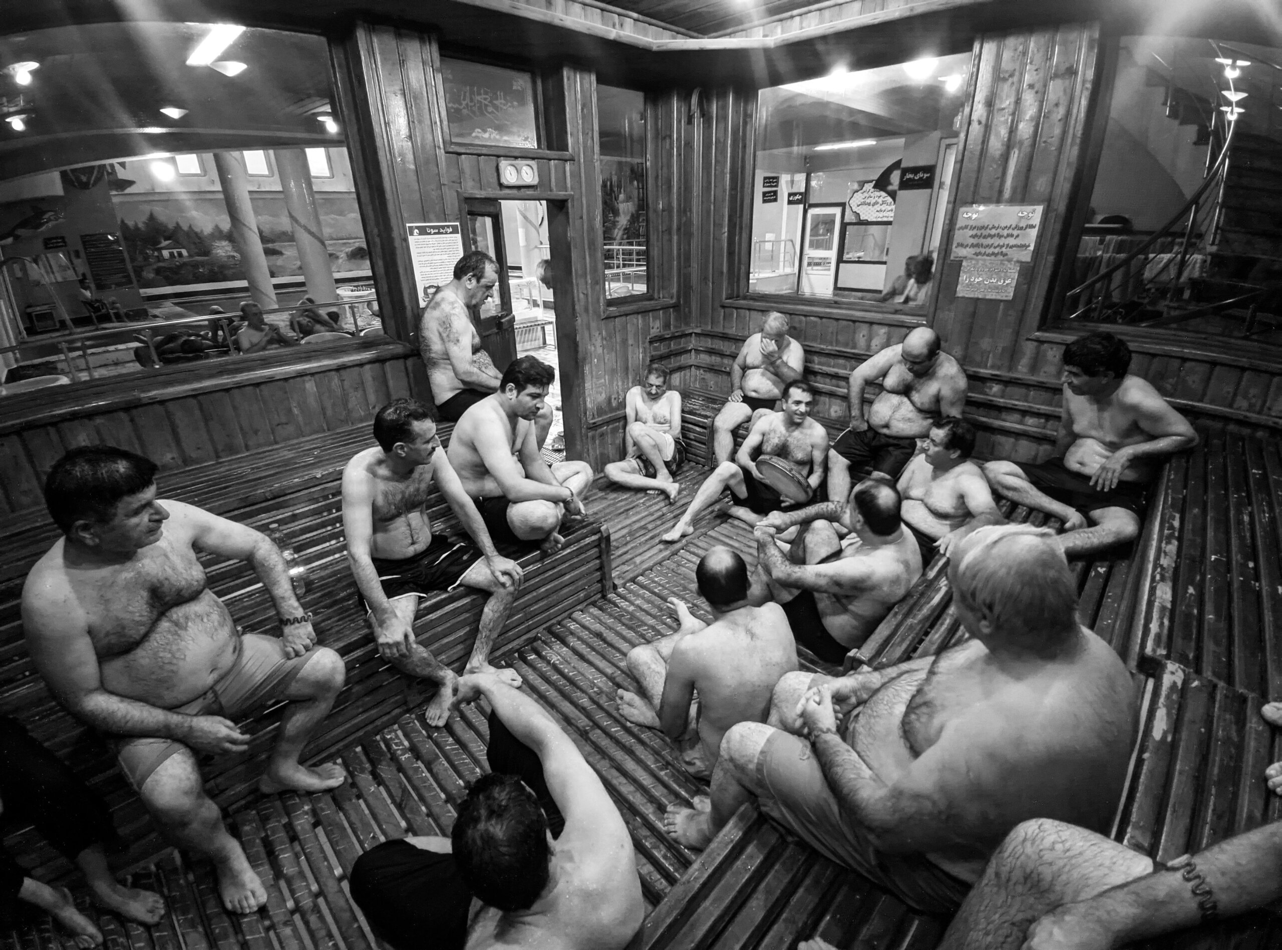 Group of men relaxing and socialising in a sauna setting, gay sauna Lisbon