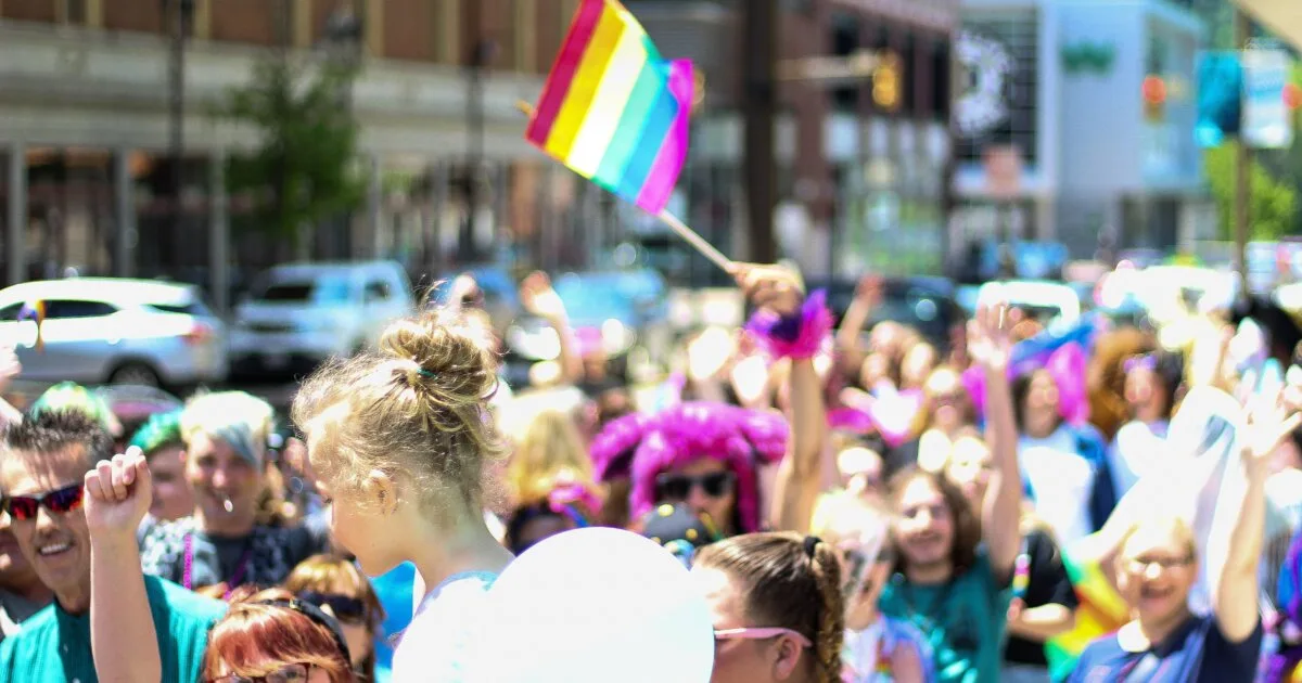 LGBTQ Pride parade with rainbow flags and a lively crowd celebrating Lisbon Pride 2026