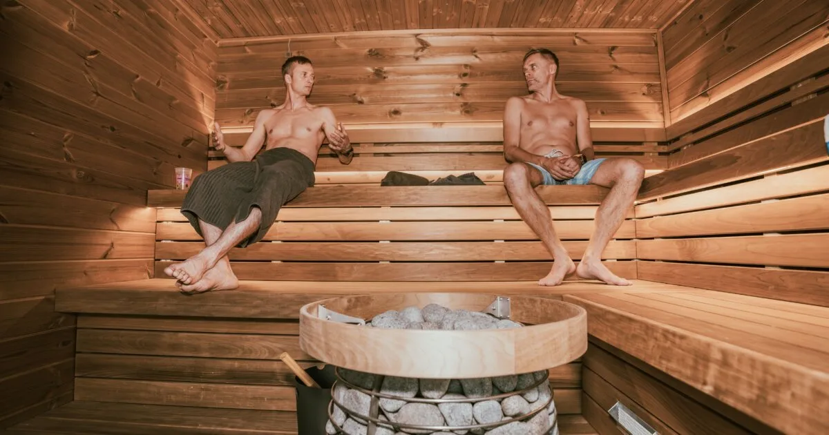 Two men relaxing in a Nordic-designed sauna, gay saunas in Lisbon