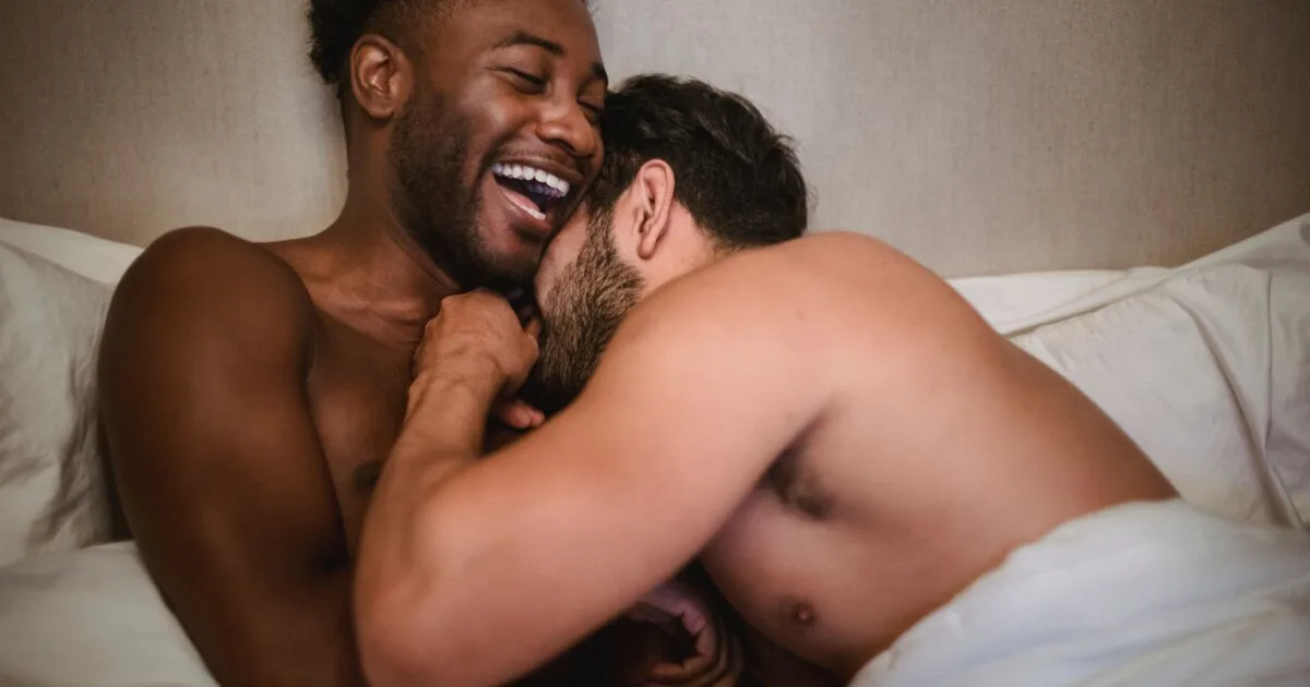 Affectionate gay couple sharing a laugh together