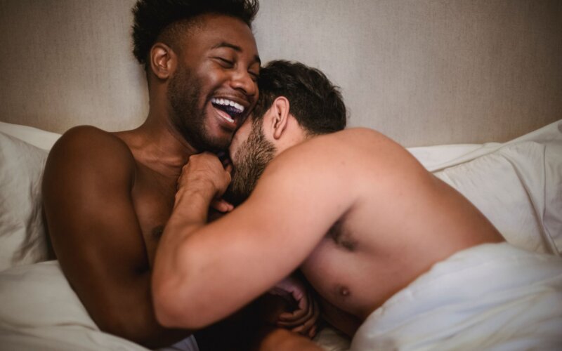 Affectionate gay couple sharing a laugh together