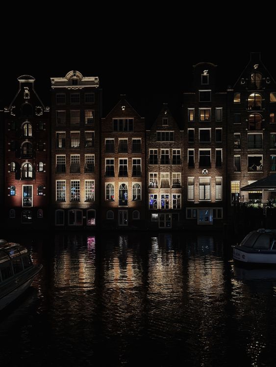Amsterdam canal houses at night - the gay scene shifting in 2026