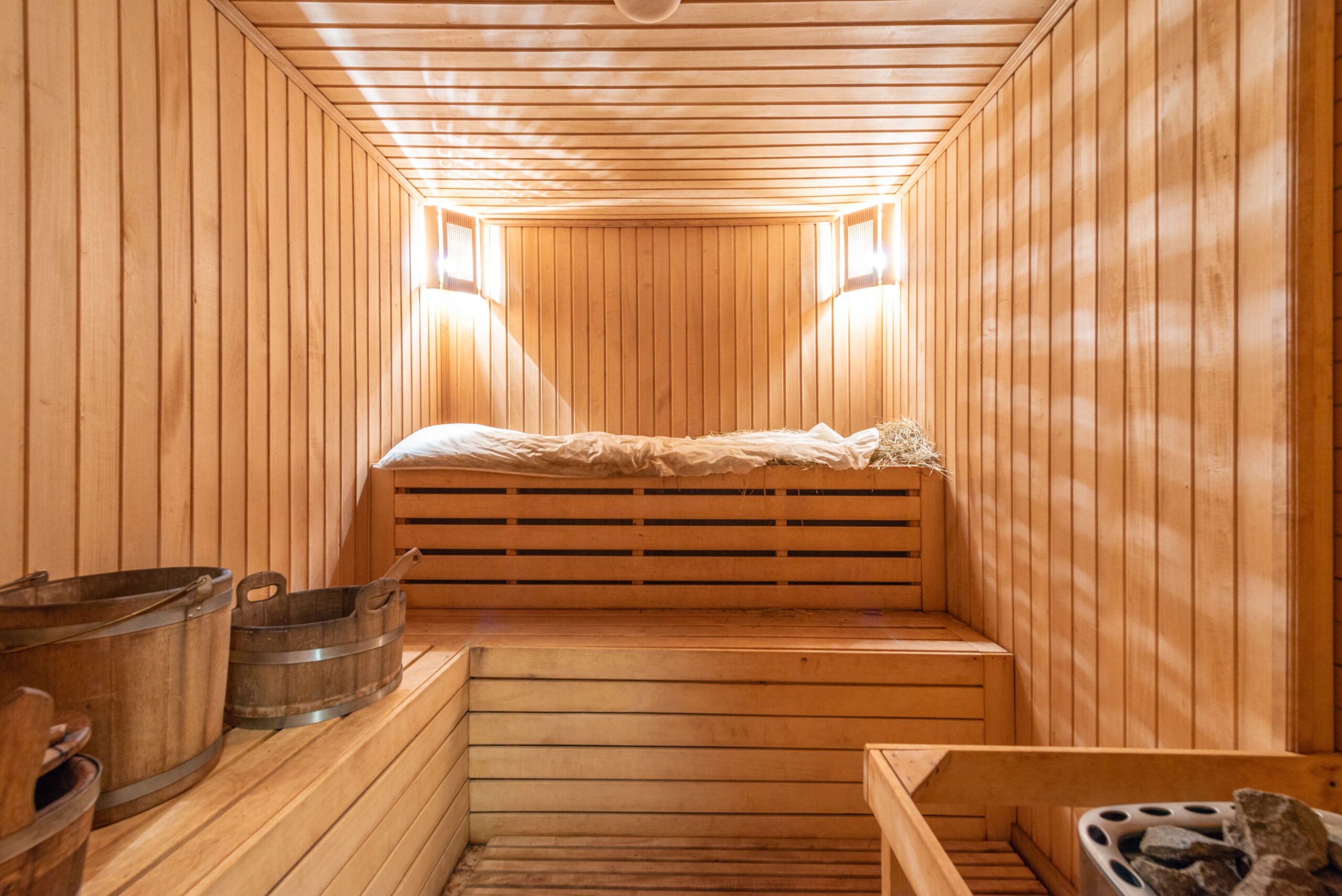 Wooden sauna interior with warm lighting, Der Boiler Berlin